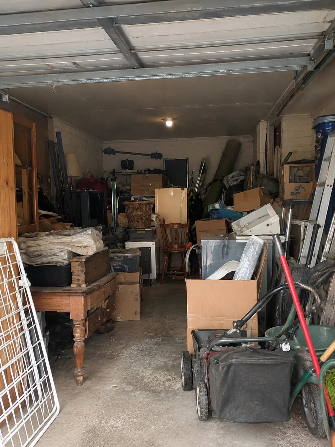 A cluttered garage before a junk removal job
